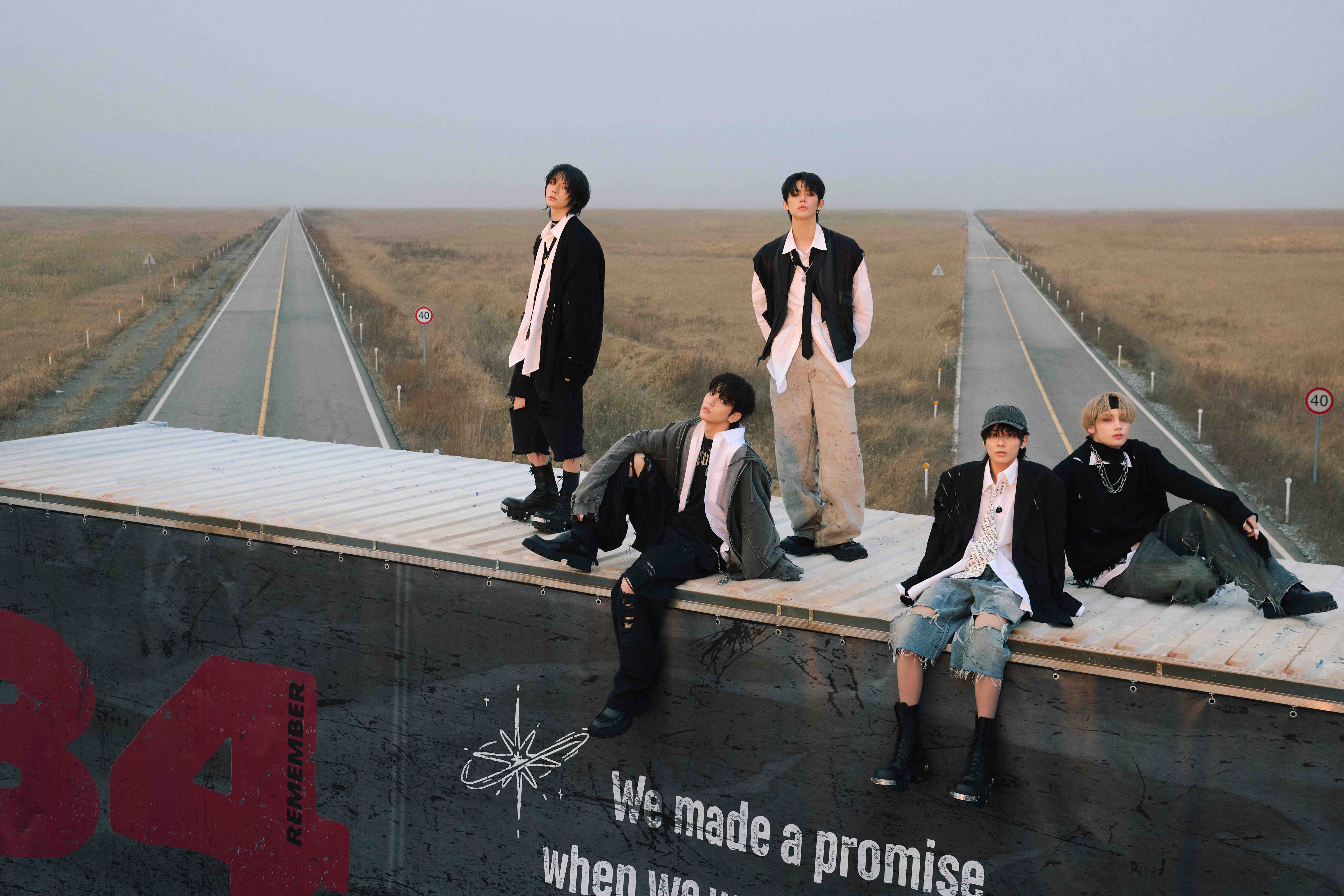 TOMORROW X TOGETHER together on a platform above roads and open fields